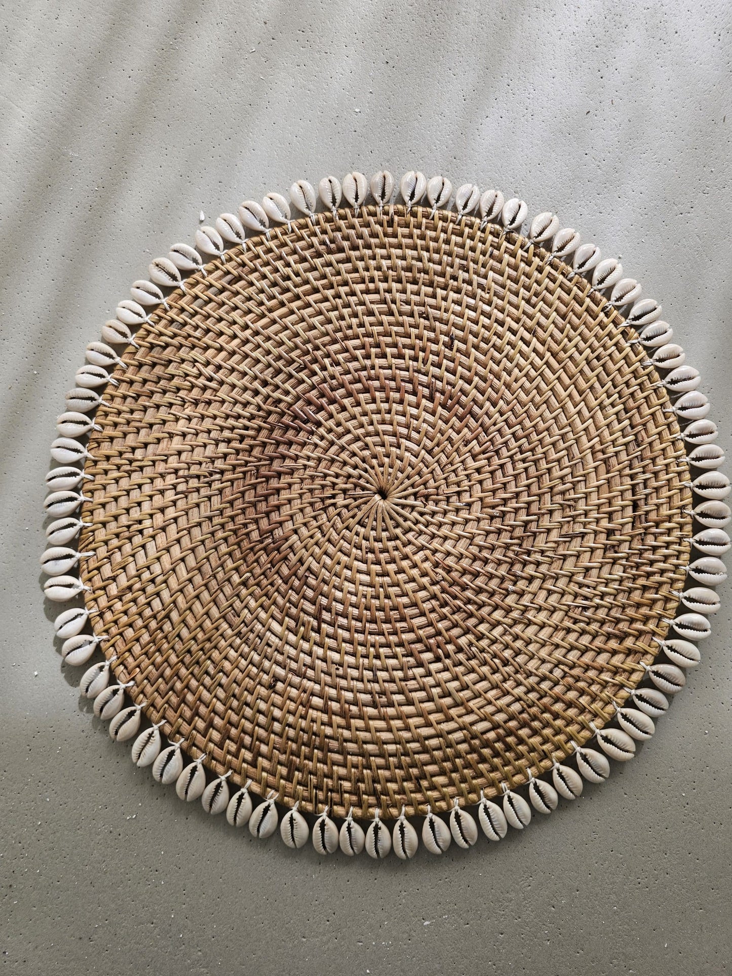 Ratan placemat decorated with shells