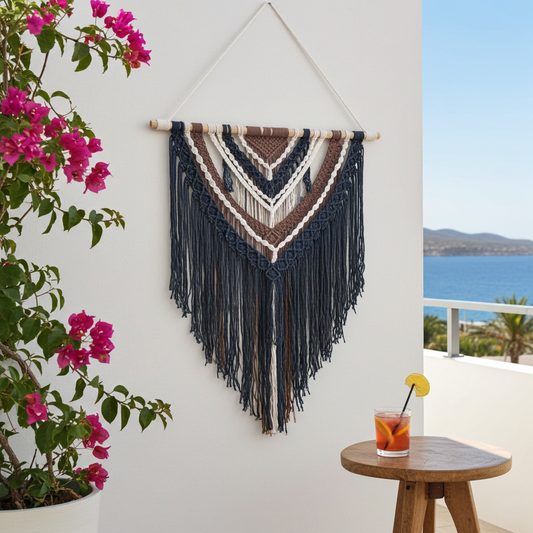 Multi-colored macramé wall hanging in black, brown, and white
